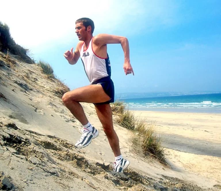 Neil Caddy hill running on sand dunes by the coast
